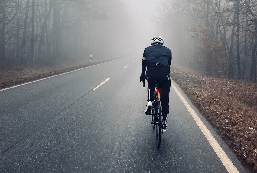 雨の日に自転車に乗る人