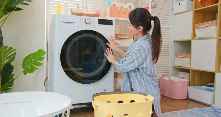 ドラム洗濯機を空けようとする女性